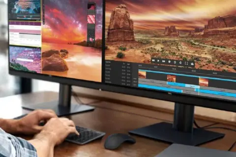 Dwie monitory wyświetlające edycję wideo i krajobraz.
